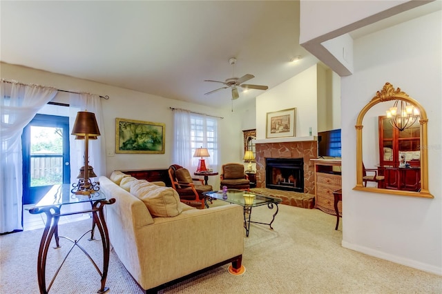 living room featuring a fireplace, plenty of natural light, ceiling fan with notable chandelier, and lofted ceiling