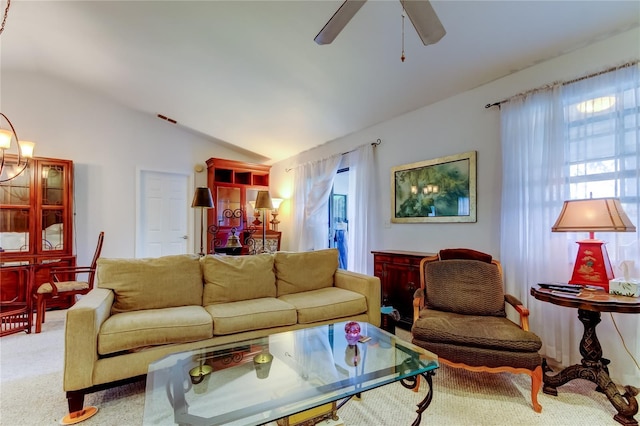 living room featuring carpet flooring, ceiling fan, and lofted ceiling