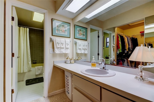 bathroom with tile patterned flooring, vanity, and shower / tub combo