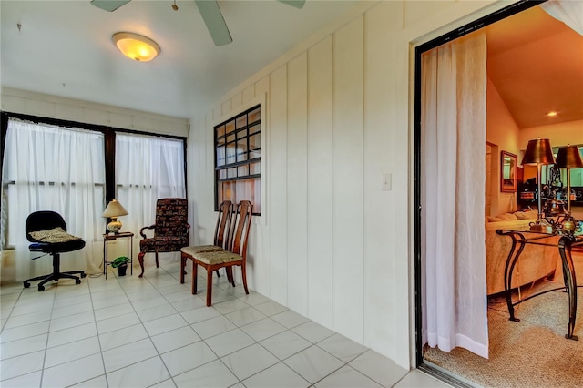 sitting room with light tile patterned floors and vaulted ceiling