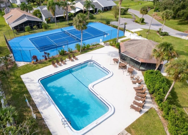 view of swimming pool featuring tennis court