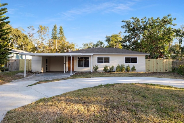 ranch-style home with a carport and a front yard