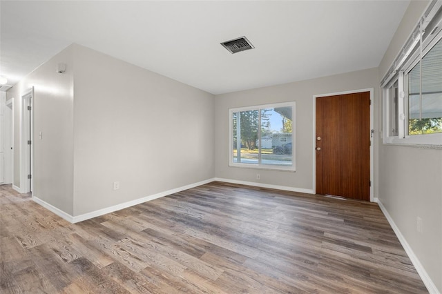 unfurnished room with hardwood / wood-style floors