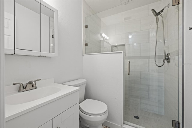 bathroom with vanity, an enclosed shower, and toilet