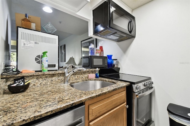 36750 US Highway 19 N Unit 01104, Palm Harbor, FL 34684 - kitchen featuring stainless steel appliances, brown cabinetry, and light stone countertops