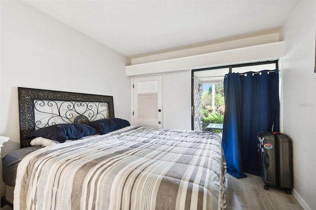 36750 US Highway 19 N Unit 01104, Palm Harbor, FL 34684 - bedroom with wood finished floors, access to exterior, and lofted ceiling