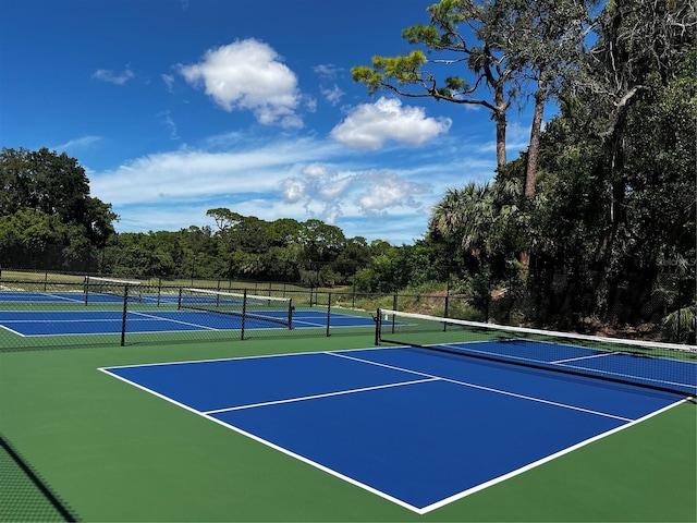 view of tennis court with basketball hoop