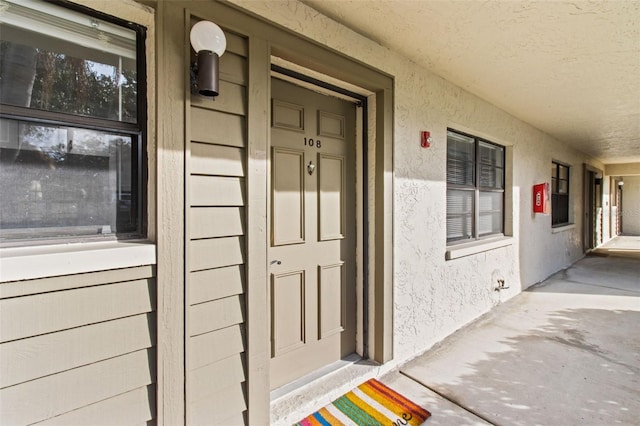 3034 Eastland Blvd Unit D108, Clearwater, FL 33761 - view of exterior entry featuring stucco siding and a porch