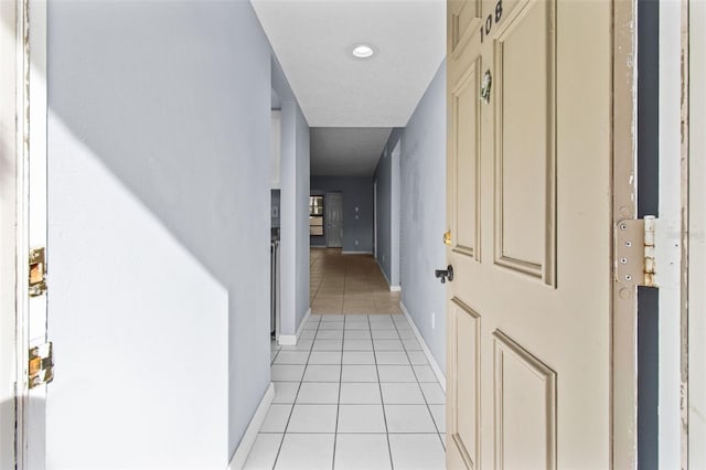 hallway featuring light tile patterned floors