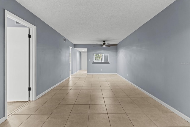 tiled spare room featuring ceiling fan and a textured ceiling