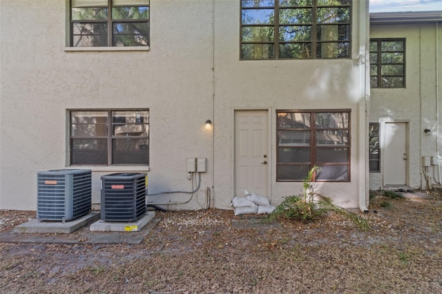 rear view of house featuring cooling unit