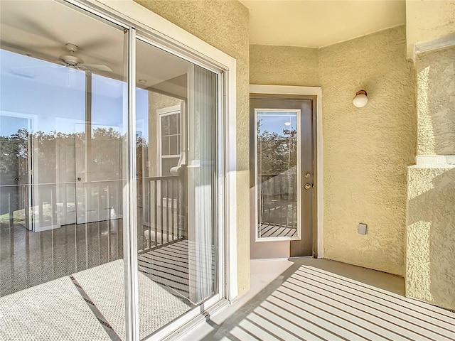 view of exterior entry with a balcony