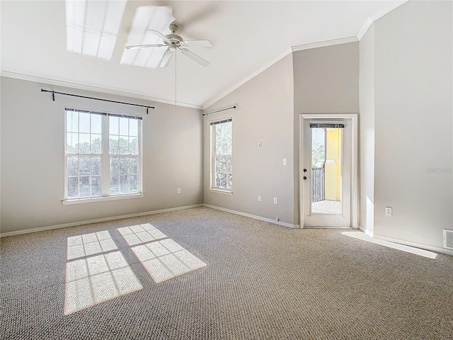 carpeted empty room with vaulted ceiling, ceiling fan, and ornamental molding