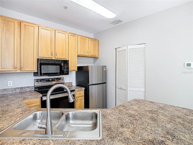 kitchen featuring light brown cabinetry, stainless steel appliances, and sink