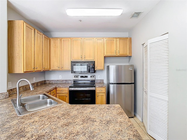 kitchen with light brown cabinets, light tile patterned floors, sink, and appliances with stainless steel finishes