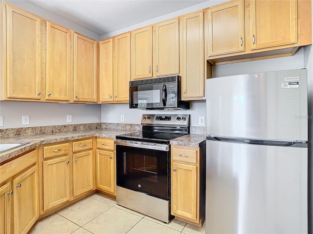 kitchen featuring light brown cabinets, light tile patterned floors, and appliances with stainless steel finishes