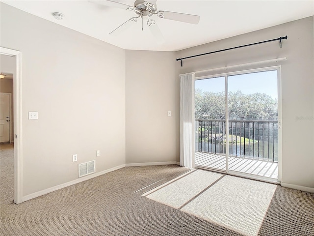 empty room featuring ceiling fan and carpet