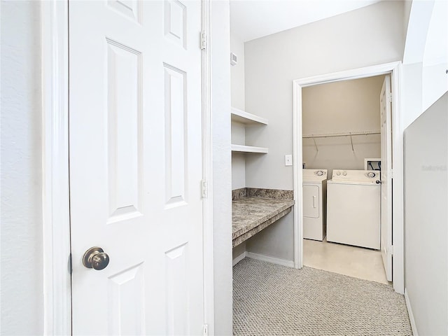 clothes washing area with washing machine and dryer