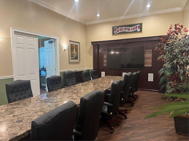 dining space with dark hardwood / wood-style flooring and crown molding