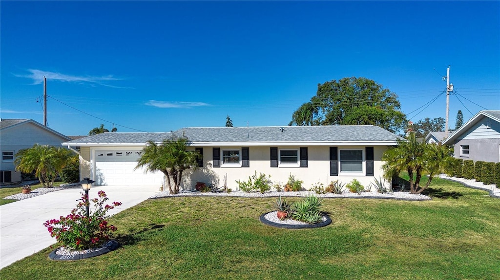 ranch-style home with a garage and a front lawn