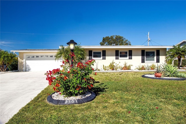 ranch-style house featuring a front yard and a garage