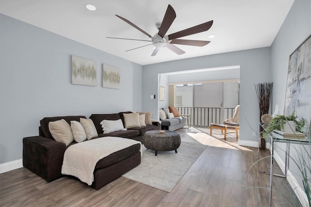 living room with hardwood / wood-style floors and ceiling fan