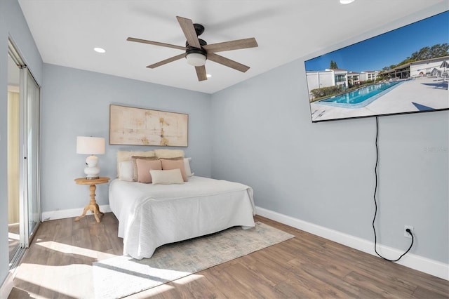 bedroom featuring ceiling fan, wood-type flooring, and a closet