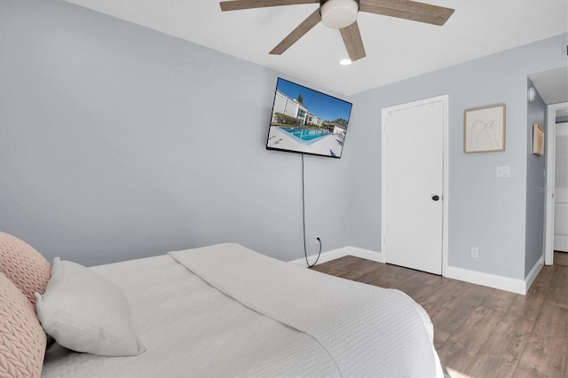 bedroom with ceiling fan and dark hardwood / wood-style floors