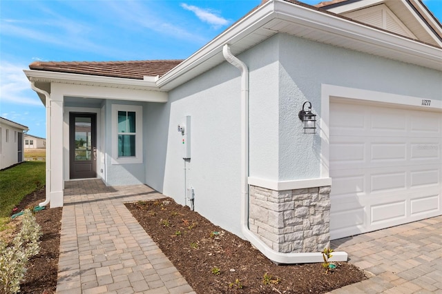 view of exterior entry with a garage