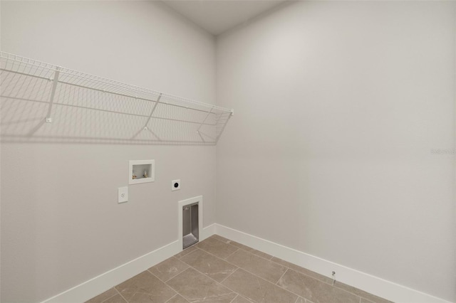 clothes washing area with electric dryer hookup, washer hookup, and tile patterned flooring