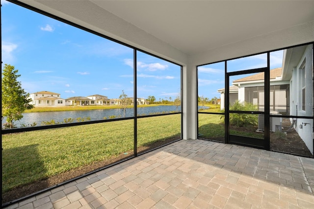 unfurnished sunroom with a water view