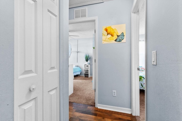 hall with dark hardwood / wood-style flooring