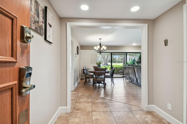 dining space with light hardwood / wood-style flooring and a notable chandelier