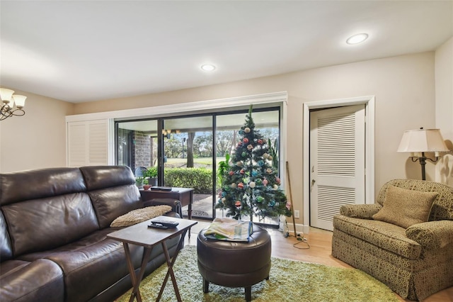 living room with a chandelier and light hardwood / wood-style flooring