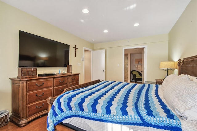 bedroom with hardwood / wood-style flooring