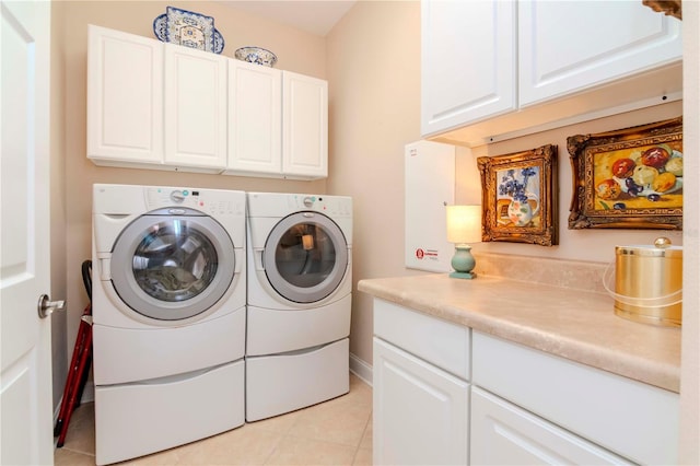 washroom featuring light tile patterned floors, cabinets, and independent washer and dryer