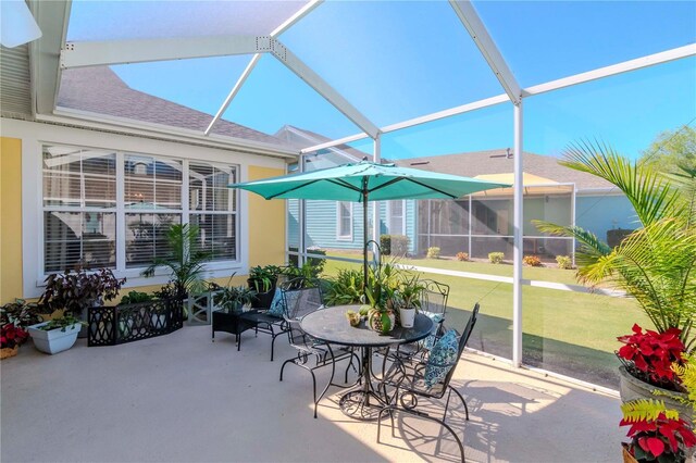 view of patio featuring a lanai