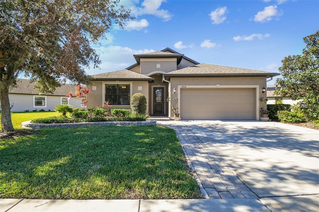 view of front of home featuring a front lawn and a garage