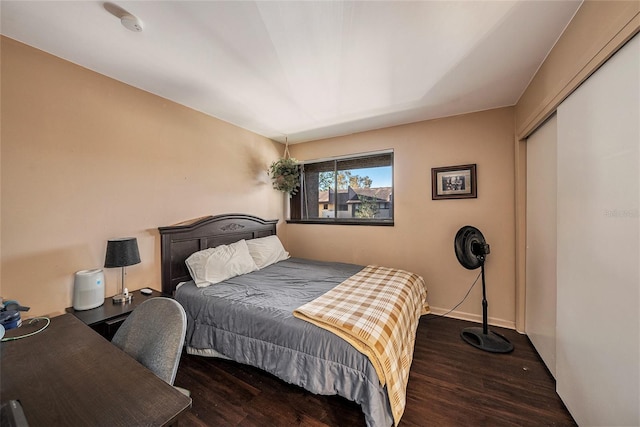 bedroom featuring dark hardwood / wood-style floors and a closet