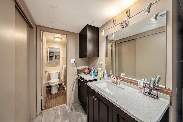 bathroom with vanity, hardwood / wood-style flooring, and toilet