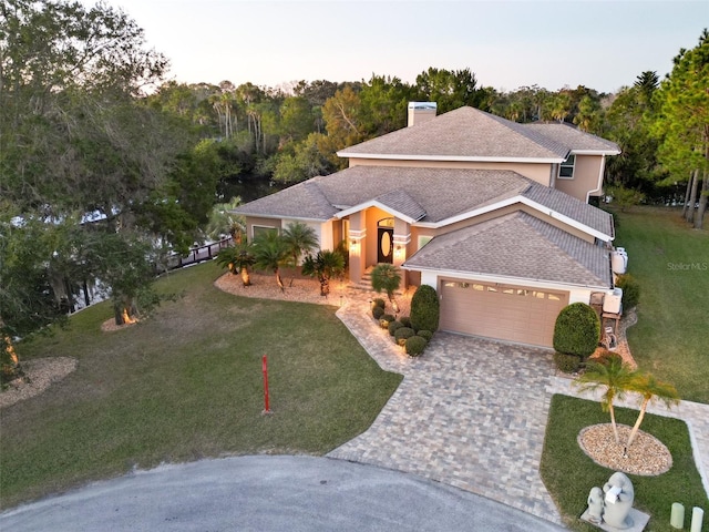 view of front of home featuring a yard and a garage