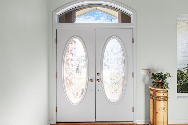 foyer entrance featuring vaulted ceiling and french doors