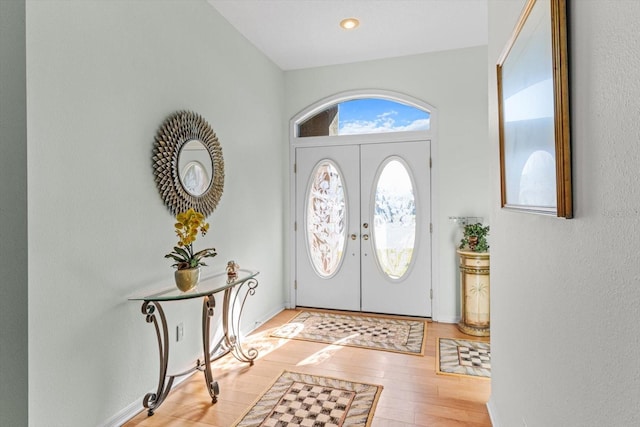 entryway with french doors and light hardwood / wood-style floors