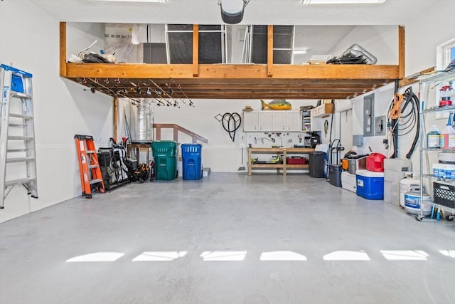 garage with a workshop area and electric panel