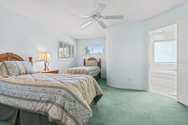 bedroom featuring carpet flooring, ceiling fan, ensuite bathroom, and a textured ceiling