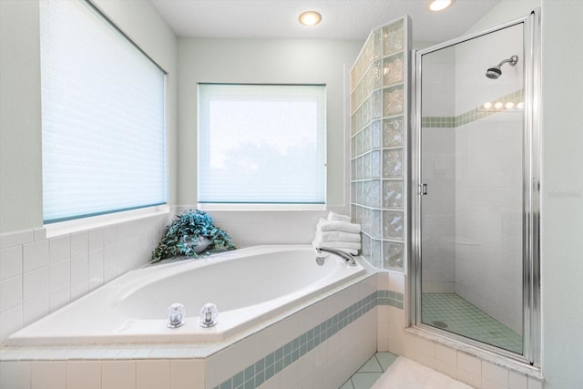 bathroom with tile patterned flooring and plus walk in shower