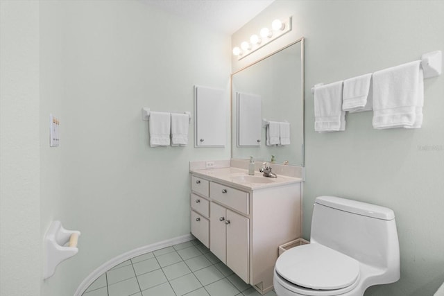 bathroom featuring tile patterned floors, vanity, and toilet