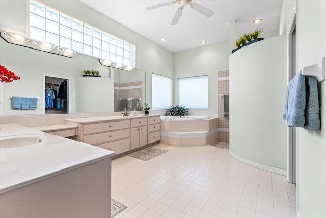 bathroom featuring vanity, tiled bath, tile patterned floors, and ceiling fan