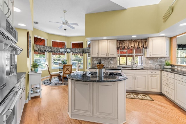 kitchen featuring plenty of natural light, sink, and backsplash