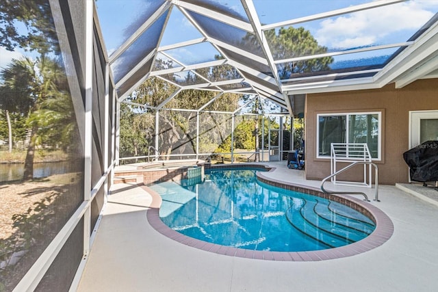 view of pool featuring a lanai, a patio, and an in ground hot tub